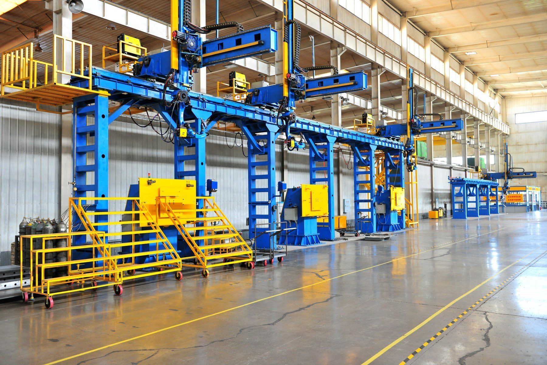 Four-arm robotic welding gantry station